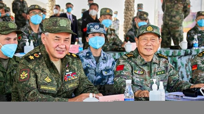 Russian Defense Minister Sergei Shoigu, L, and Chinese Defense Minister Wei Fenghe watch a joint military exercise held in the Ningxia Hui Autonomous Region in northwestern China, Aug. 13, 2021. (Russian Defense Ministry Press Service/Handout)