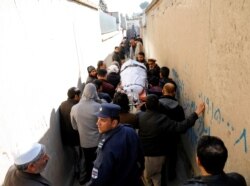 Relatives carry the body of one of the female judges shot dead by unknown gunmen in Kabul, Afghanistan, Jan. 17, 2021.