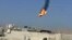 This citizen journalism image purports to show a Syrian military helicopter on fire and falling to the ground after it was apparently hit during fighting between government forces and rebels in Damascus, Aug 27, 2012. AP IS UNABLE TO INDEPENDENTLY VERIFY 