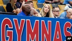 FILE - USA Gymnastics President and CEO Kerry Perry (C) watches the U.S. Gymnastics Championships, in Boston, Aug. 16, 2018.