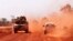FILE - Troops drive to Segou, Jan. 16, 2013. Gunmen ambushed a convoy Tuesday, killing four soldiers.