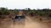 FILE - Anti-rhino poaching troops simulate a hunt for poachers in the Madikwe Game Reserve, Botswana, Nov. 8, 2013.