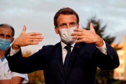 French President Emmanuel Macron speaks after meeting with the medical staff of the Rene Dubos hospital center, in Pontoise, outside Paris, Oct. 23, 2020.