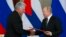 FILE - Russian President Vladimir Putin (R) and Cuban President Miguel Diaz-Canel, exchange documents after their talks in the Kremlin, in Moscow, Russia, Nov. 2, 2018.