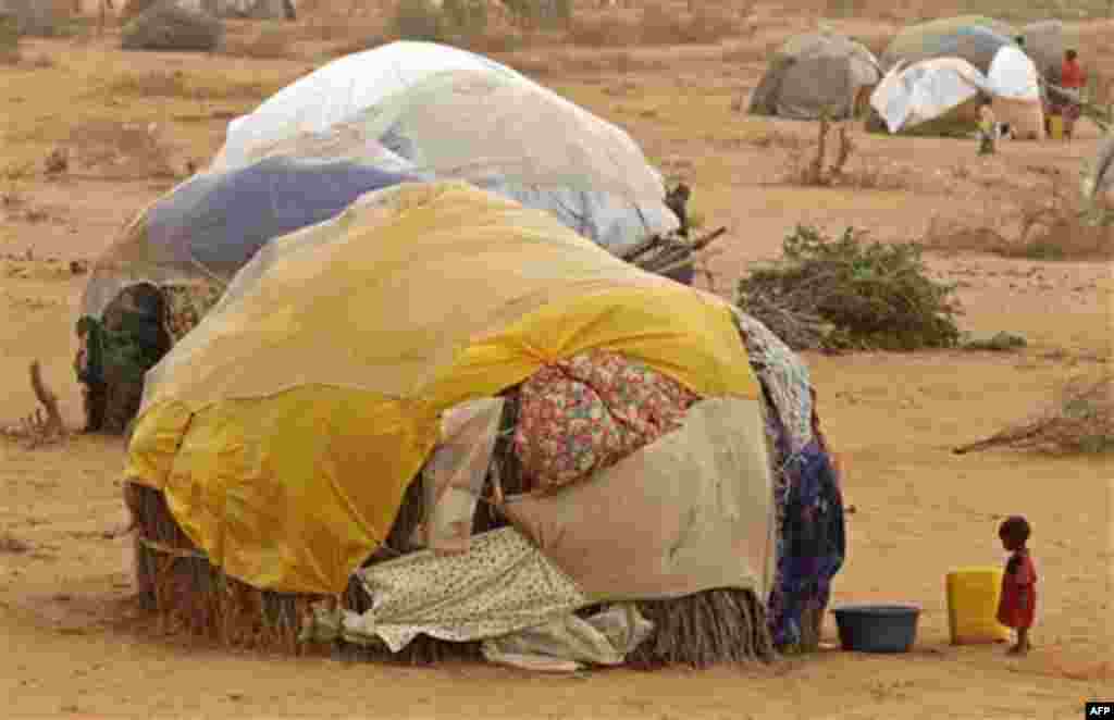 A child stands in front of her home at a refugee camp in Dadaab, Kenya, Thursday, Aug 4, 2011. Dadaab, a camp designed for 90,000 people now houses around 440,000 refugees. Almost all are from war-ravaged Somalia. Some have been here for more than 20 year