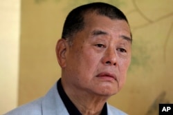 FILE - Hong Kong media tycoon Jimmy Lai pauses during an interview in Hong Kong on July 1, 2020.