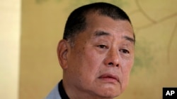 FILE - Hong Kong media tycoon Jimmy Lai pauses during an interview in Hong Kong on July 1, 2020. 