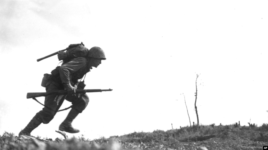 Pfc. Paul Ison, a U.S. Marine runs through Japanese gunfire on Okinawa, May 10, 1945.