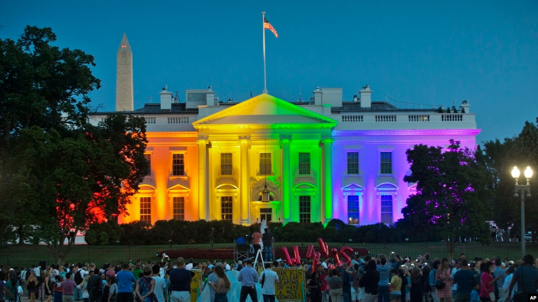 People gather in Lafayette Park to see the White House illuminated with rainbow colors in commemoration of the Supreme Court's ruling to legalize same-sex marriage in Washington, June 26, 2015.