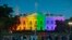 People gather in Lafayette Park to see the White House illuminated with rainbow colors in commemoration of the Supreme Court's ruling to legalize same-sex marriage in Washington, June 26, 2015.
