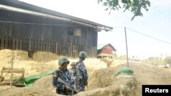 Myanmar border guard police stand guard at Goke Pi outpost in Buthidaung during a government organized media tour in Rakhine