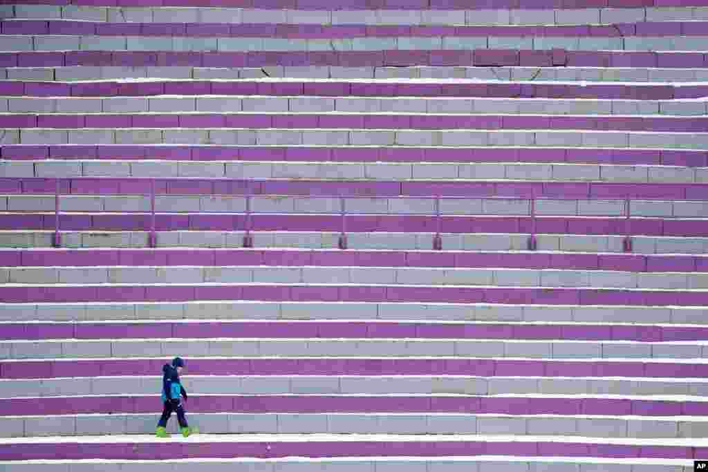 A lone spectator stands during competition jumps at the the third stage of the 69th Four Hills ski jumping tournament in Innsbruck, Austria.