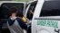 FILE - Families who crossed the nearby U.S.-Mexico border near McAllen, Texas, are placed in a Border Patrol vehicle, March 14, 2019. U.S. border authorities have increased the biometric data they take from children 13 and younger.