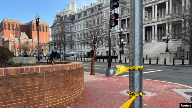 Police tape remains at the scene of an overnight shooting on a street bordering the White House complex, after Secret Service say they shot a man brandishing a firearm in Washington, March 9, 2025. 