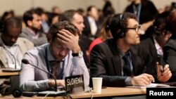 FILE - Delegates attend the closing session of the 19th conference of the U.N. Framework Convention on Climate Change (COP19) in Warsaw, Nov. 22, 2013. In December 2018, Poland will host the annual U.N. climate talks for the third time.