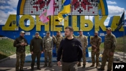 Ukrainian President Volodymyr Zelenskyy poses for a photo with Ukrainian soldiers in front of a road sign marking the entrance to the Donetsk region, amid the Russian invasion of Ukraine. (Ukrainian Presidential Press Service via AFP)