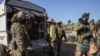 Syrian opposition fighters get off a truck as they enter the village of Anjara, western outskirts of Aleppo, Nov. 28, 2024, part of their major offensive on government-controlled areas in the country's northwestern.