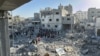 Palestinians inspect the damage after an overnight Israeli airstrike in Beit Lahia the northern Gaza Strip, Oct. 27, 2024.