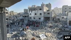 Palestinians inspect the damage after an overnight Israeli airstrike in Beit Lahia the northern Gaza Strip, Oct. 27, 2024.