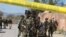 Pakistani soldiers cordon off the area of suicide bombing in Charsadda, Pakistan, Feb. 21, 2017. Police say three suicide bombers attacked a courthouse in northwestern Pakistan