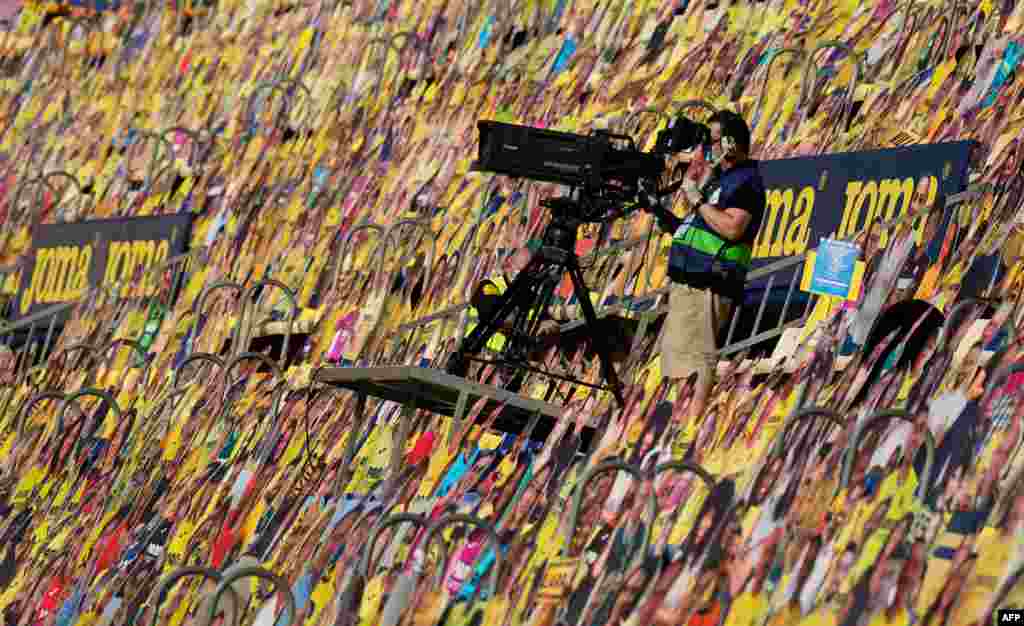 A cameraman works among cardboards of fans prior to the Spanish League football match Villarreal CF against Sevilla FC at La Ceramica stadium in Vila-real, Spain, June 22, 2020.