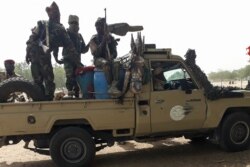 FILE - Soldiers of the Chad Army sit on the back of a Land Cruiser at the Koundoul market, 25 km from N'Djamena, Jan. 3, 2020, upon their return after a months-long mission fighting Boko Haram in neighboring Nigeria.