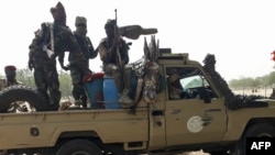 FILE - Soldiers of the Chad Army sit on the back of a Land Cruiser at the Koundoul market, 25 km from N'Djamena, Jan. 3, 2020, upon their return from a mission fighting Boko Haram.
