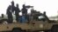 FILE - Soldiers of the Chad Army sit on the back of a Land Cruiser at the Koundoul market, 25 km from N'Djamena, Jan. 3, 2020, upon their return after a months-long mission fighting Boko Haram in neighboring Nigeria.