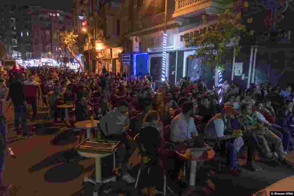 While many polls sat empty, some Egyptians flocked to cafes like this one in central Cairo, where they showed their patriotism by cheering for Egypt's team in a friendly football match against Greece, March 27, 2018.