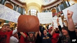 Opponents of Wisconsin Gov. Scott Walker's bill to eliminate collective bargaining rights for many state workers pack the rotunda at the State Capitol in Madison, Wisconsin, Feb. 17, 2011