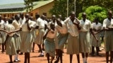 FILE - In this photo taken July 30, 2017, girls take a break at the Loreto Secondary School, the region's only all-girls boarding school where staff require each girl's guardian to sign a form promising not to remove the child from school until graduation, in the town of Rumbek, South Sudan.