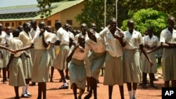 FILE - In this photo taken July 30, 2017, girls take a break at the Loreto Secondary School, the region's only all-girls boarding school where staff require each girl's guardian to sign a form promising not to remove the child from school until graduation, in the town of Rumbek, South Sudan.