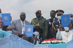 Chairman of Sudan's Sovereign Council Abdel Fattah al-Burhan, from left, South Sudan's President Salva Kiir and Chadian President Idriss Deby hold a copy of the South Sudan peace deal, signed in Juba on Oct. 3, 2020.