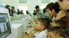 Visitors watch as Cambodian orphans learn computer skills and exploring the Internet world during the opening ceremony at the Future Light Orphanage on the outskirt of Phnom Penh, file photo. 