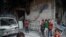 Children are seen near rubble of damaged buildings in the eastern Damascus suburb of Ghouta, Syria, July 17, 2017.