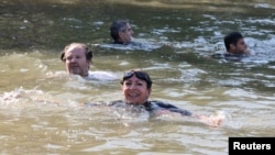 Paris Mayor Anne Hidalgo swims in the Seine, to demonstrate that the river is clean enough to host the outdoor swimming events at the Paris Olympics later this month, in Paris, July 17, 2024.