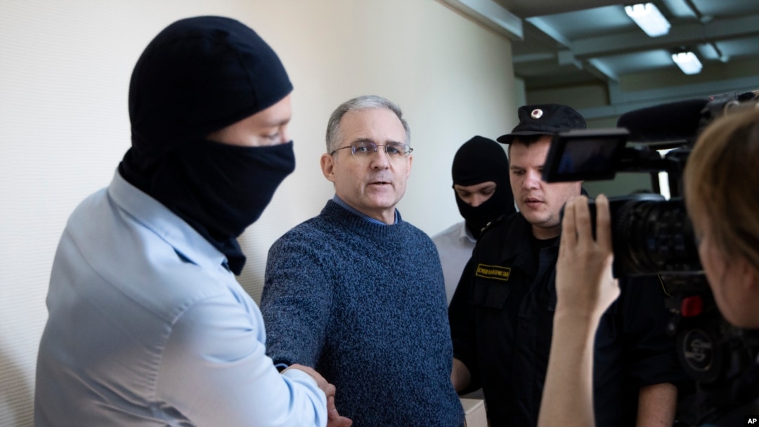 FILE - Paul Whelan, a former U.S. Marine, second left, who was arrested for alleged spying in Moscow at the end of 2018, is escorted by Federal Security Service officers to a court room in Moscow, Russia, Aug. 23, 2019.