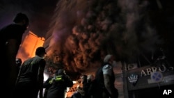 Firefighters and rescuers stitchery  extracurricular  a machine  store  deed  successful  an Israeli airstrike successful  cardinal  Beirut, Nov. 17, 2024.