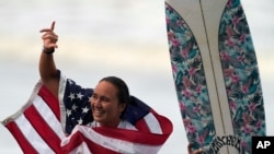 FILE - Carissa Moore of the United States celebrates winning the gold medal in the women's surfing competition, July 27, 2021, at the 2020 Summer Olympics at Tsurigasaki beach in Ichinomiya, Japan.