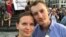 FILE - Ukrainian activist Lyudmyla Kozlovska (L), and her husband Bartosz Kramek are seen during an anti-government protest in Warsaw, Poland, Aug. 10, 2017.