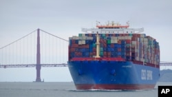 FILE - In this May 14, 2019, photo, a Cosco Shipping container ship passes the Golden Gate Bridge in San Francisco bound for the Port of Oakland.