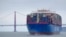 FILE - In this May 14, 2019, photo, a Cosco Shipping container ship passes the Golden Gate Bridge in San Francisco bound for the Port of Oakland.