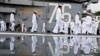 FILE - Crew of the U.S. navy aircraft carriers USS Ronald Reagan rig a ship for the voyage at the US navy's Yokosuka base, May 16, 2024, in Yokosuka, south of Tokyo. This is the ship's final departure from Yokosuka before transiting back to the US.