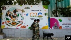 FILE - Indian paramilitary soldiers with a sniffer dog frisk the area near the venue ahead of this week's summit of the Group of 20 nations, in New Delhi, India, Thursday, Sept. 7, 2023. 