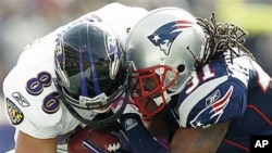 Baltimore Ravens tight end Todd Heap, left, takes a hit from New England Patriots safety Brandon Meriweather during an NFL football game at Gillette Stadium in Foxborough, Mass., 17 Oct 2010