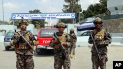 FILE - In this Aug. 31, 2021, photo, Taliban special forces fighters stand guard outside the Hamid Karzai International Airport after the U.S. military's withdrawal, in Kabul, Afghanistan.