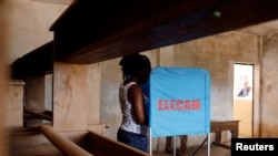 FILE - A woman casts her vote at a polling station during elections, in Yaounde, Cameroon, Oct. 7, 2018.