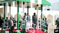 Nigeria's President Bola Ahmed Tinubu, center right, and Indian Prime Minister Narendra Modi stand on the podium before a meeting, at the Presidential Villa, in Abuja, Nigeria, Nov. 17, 2024. 