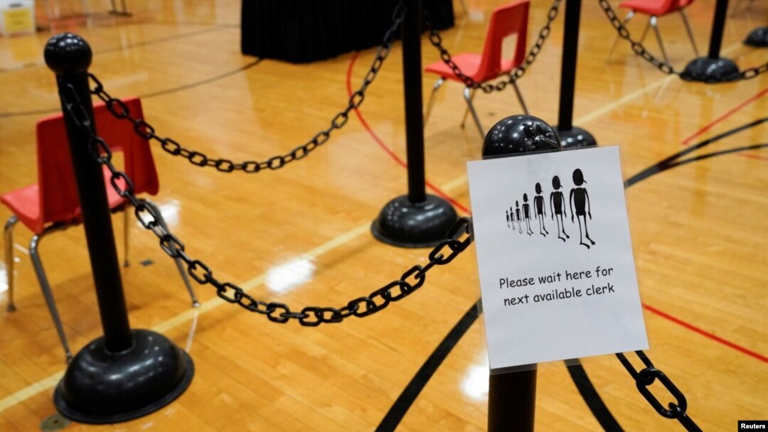 A sign for voters is seen in a polling area ahead of Election Day at the Waterville Junior High School in Waterville, Maine, Nov. 2, 2020.