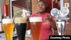 Brewer Happy Sekanka with some of her unique craft beers inside Oakes Brew House in Johannesburg. (VOA / Darren Taylor)